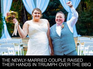 The newly-married couple raised their hands in triumph over the BBQ.